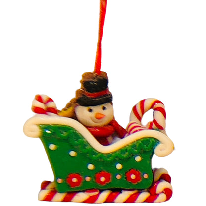 32943 - Claymatic 3D Snowman In Green Sleigh Ornament 4 Inch Tall Holiday |Pod 2-61|