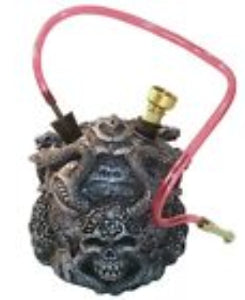 A black hookah pipe with gothic skull designs and a pink hose attached.