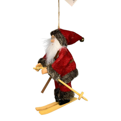 Martial Arts Supply Santa Claus ornament dressed in red with brown trim, skiing on wooden skis with poles.
